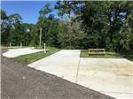 Two empty RV sites with picnic benches at THE PRESERVE RV PARK - thumbnail