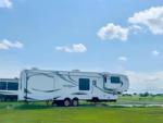 Large fifth wheel in a grassy site at Cherokee Creek RV Park - thumbnail