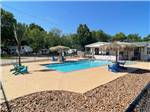 The swimming pool with lounge chairs at LAKE CONROE RV CAMPGROUND BY RJOURNEY - thumbnail