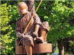 A statue of a boy fishing at BRIDGEPORT MARINA RV PARK - thumbnail