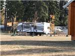 View larger image of Picnic benches next to a trailer at PACIFIC PALMS RV RESORT image #4