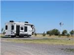 A fifth wheel trailer in a gravel site at COYOTE KEETH'S RV PARK - thumbnail