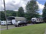 Fifth wheel trailer and truck parked in site at NEW RIVER BRIDGE FAMILY CAMPGROUND - thumbnail