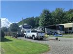 A white truck and Cougar trailer parked in a gravel site at NEW RIVER BRIDGE FAMILY CAMPGROUND - thumbnail