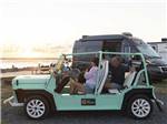 A couple and their dog sitting in a Jeep at SUN OUTDOORS CHINCOTEAGUE BAY - thumbnail