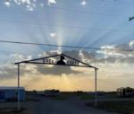 sunburst and cloud behind sign at Back Forty RV Park - thumbnail