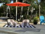 Lounge chairs under an umbrella - thumbnail