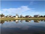 Rental cabins reflecting on water at SOUTHBOUND RV PARK AND CABINS - thumbnail