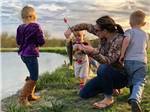 A woman prepping children for fishing at SOUTHBOUND RV PARK AND CABINS - thumbnail
