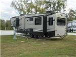 A fifth wheel trailer with its slide outs in a RV site at ROYAL OAKS RV PARK - thumbnail