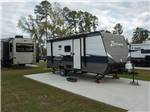 A black and gray travel trailer at ROYAL OAKS RV PARK - thumbnail