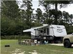 A travel trailer parked in a RV site at MIDPOINT I-95 RV PARK - thumbnail
