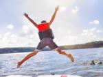A kid jumping into a lake - thumbnail