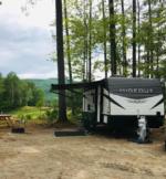 Wooded RV site with mountain views at Lone Mountain River Front Campground - thumbnail