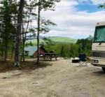Panic area with RV and cabin at site Lone Mountain River Front Campground - thumbnail