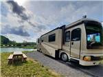A motorhome parked in a gravel site at MAMMOTH RIDGE RV PARK - thumbnail