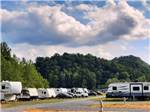A row of travel trailers parked in gravel sites at MAMMOTH RIDGE RV PARK - thumbnail