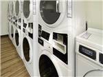 Laundry room with stacked washers and driers at Medical Center RV Resort - thumbnail