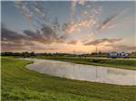 The sun sets over grass park grounds at Medical Center RV Resort - thumbnail