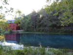 Red barn near a pond at Eminence Cottages and Camp - thumbnail