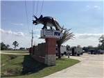 The front entrance sign with a statue on the top at GATOR RV PARK - thumbnail