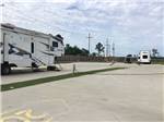 A fifth wheel parked at a site at Gator RV Park - thumbnail