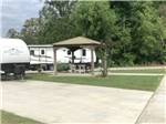 Covered sitting area next to a site at Gator RV Park - thumbnail