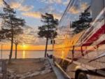 A class A parked on a paved site at sunset at The Regatta on Grand RV Resort - thumbnail