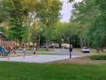 Playground, basketball court and grassy area at Pipestem RV Park and Campground - thumbnail