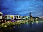 RVs lined up by the water - thumbnail