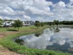 View of an RV site by the water at Plantation Place RV Park - thumbnail