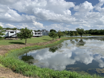 View of an RV site by the water at Plantation Place RV Park - thumbnail