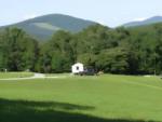 Parked trailer with large grass area at Blue Bear Mountain Camp - thumbnail