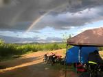 Campsite overlooking a valley with a rainbow in the sky - thumbnail