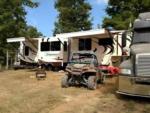 Parked RV and ATV in campsite - thumbnail