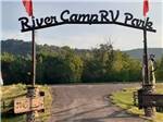 "River Camp RV Park" arch leading into RV Park - thumbnail