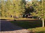 Grassy lawn next to road, overlooking RV campground - thumbnail