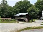A two story building with a picnic bench at PLUMTREE CAMPGROUND AND RETREAT - thumbnail
