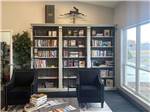 A large bookshelf in the dining area at WHISTLESTOP LUXURY RV PARK - thumbnail