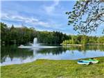 Fountain in the pond and kayaks on the shore - thumbnail