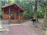 A rustic rental cabin with a porch - thumbnail