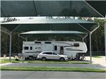 A fifth wheel trailer parked in a shaded site at LAUREL SPRINGS RV RESORT - thumbnail