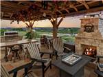 Chairs and tables under a pergola at FIREFLY LUXURY RV RESORT - thumbnail