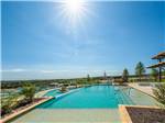 The sun in shining bright on the pool at FIREFLY LUXURY RV RESORT - thumbnail