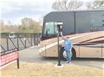 A couple entering the front entrance gate at TIFTON OVERNIGHT RV - thumbnail