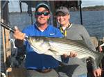 A father and son showing off the fish they caught at BELLS MARINA RV RESORT - thumbnail