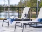 Two pool-side lounge chairs at SWEET CITRUS ACRES RV RESORT - thumbnail