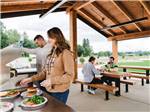 People eating in the outdoor pavilion at ANGEL OF THE WINDS RV RESORT - thumbnail