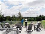 A couple enjoying the view from a patio area at ANGEL OF THE WINDS RV RESORT - thumbnail