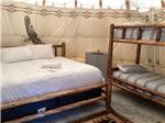 The bed and bunk beds inside the teepee rental at GOD'S COUNTRY RESORT - thumbnail